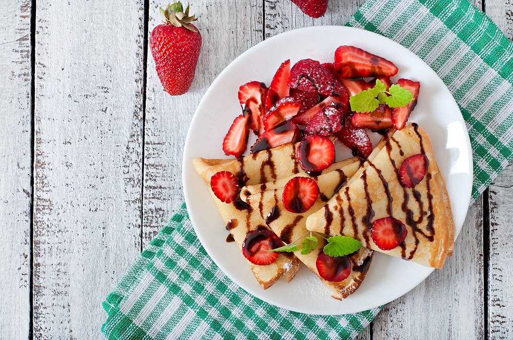 pancakes with strawberries chocolate decorated with mint leaf